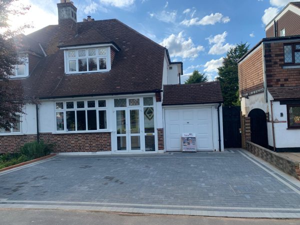 Fitting paving on a driveway in Bletchingley, Surrey