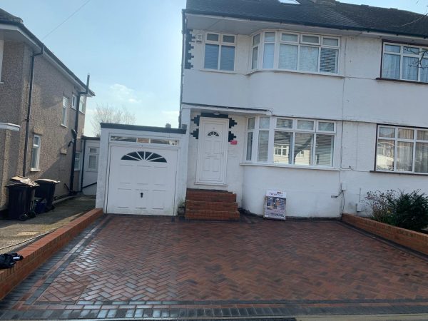 Fitting paving on a driveway in Eastfields, London