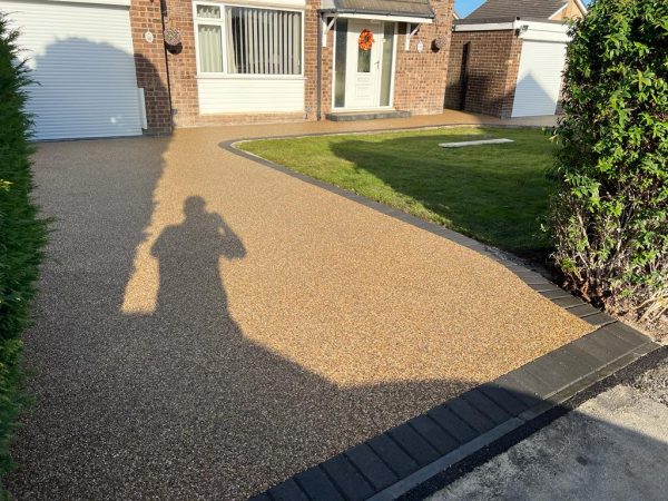 Laying resin surface on a driveway in Sidlow, Surrey